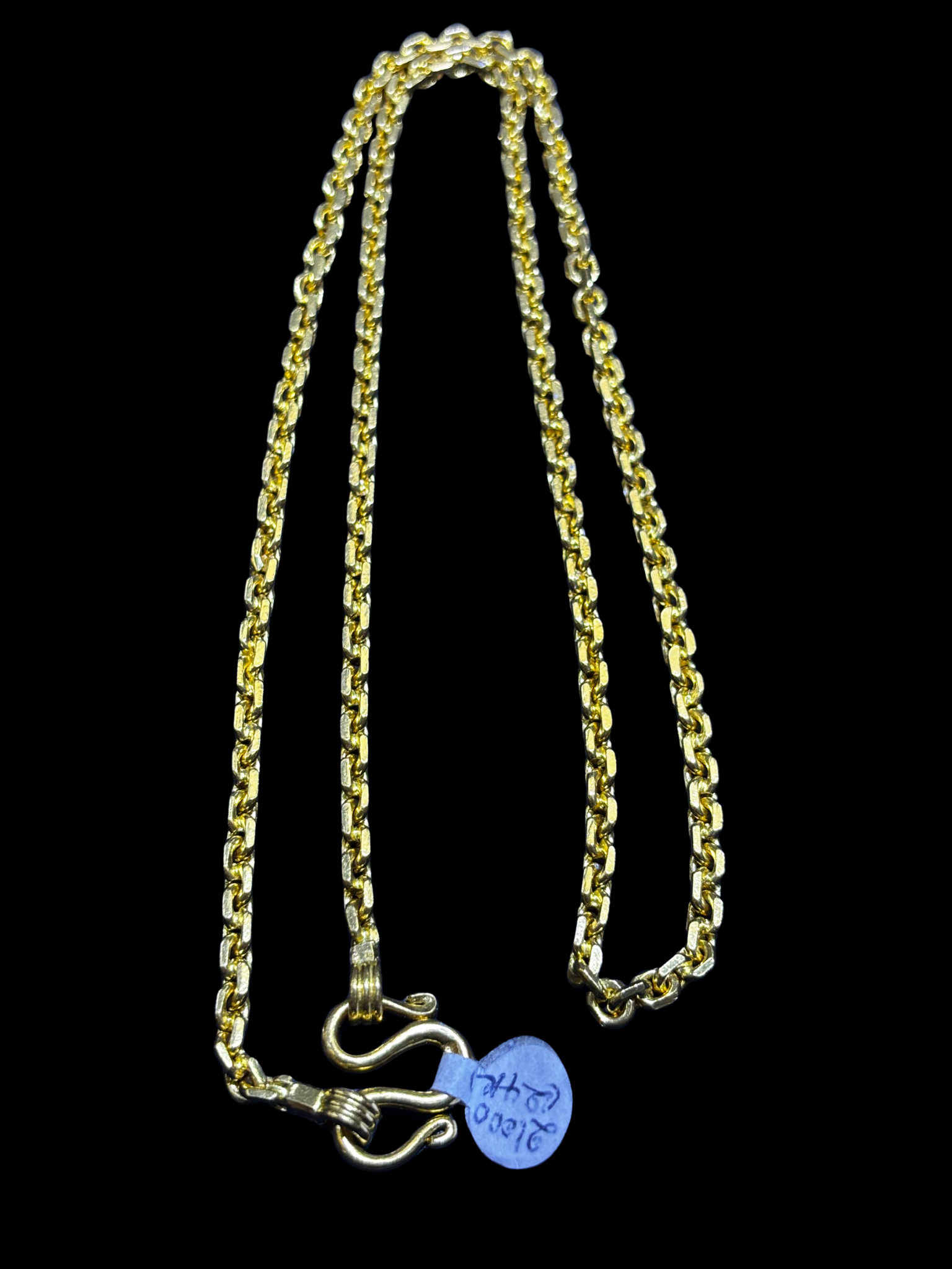 24K gold chain link necklace with clasp on a black background